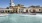 a large building with a pool in front of it