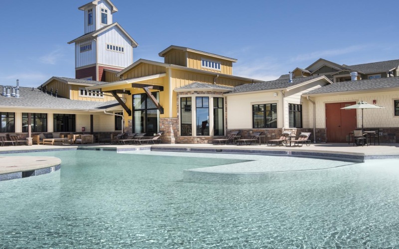 a large building with a pool in front of it