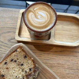 a cup of coffee and bread on a table