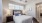 a bedroom with a bed and a fan